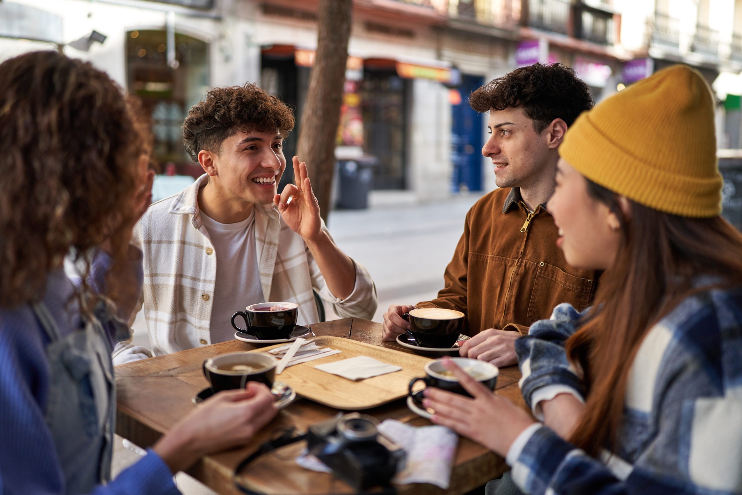 A multicultural group of friends enjoying coffee and tea after t