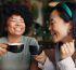 people friends laughing with coffee cafe funny joke discussion break together happy group smile enjoying fun conversation with beverage croissant cup tea indoor restaurant