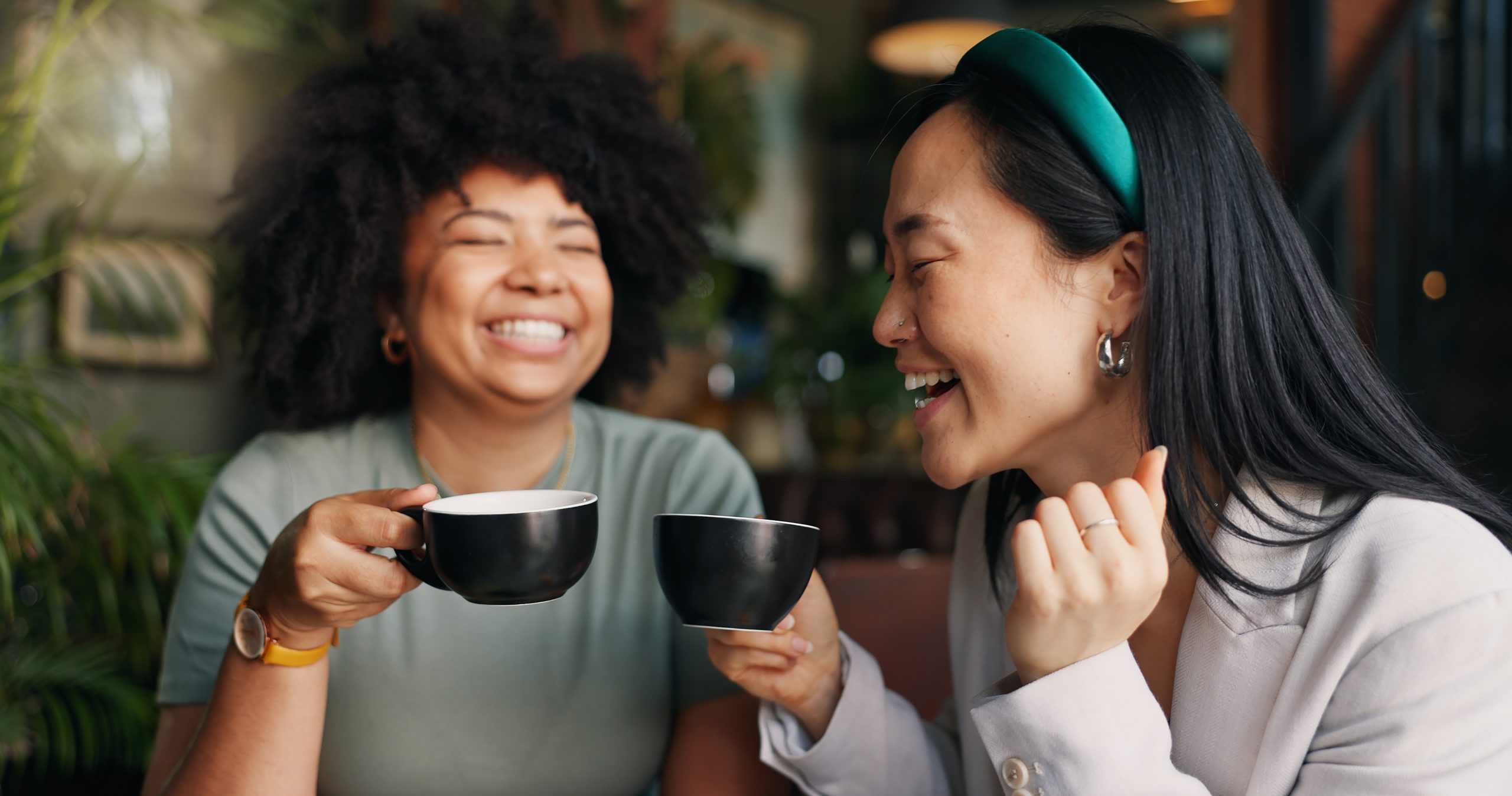 people friends laughing with coffee cafe funny joke discussion break together happy group smile enjoying fun conversation with beverage croissant cup tea indoor restaurant