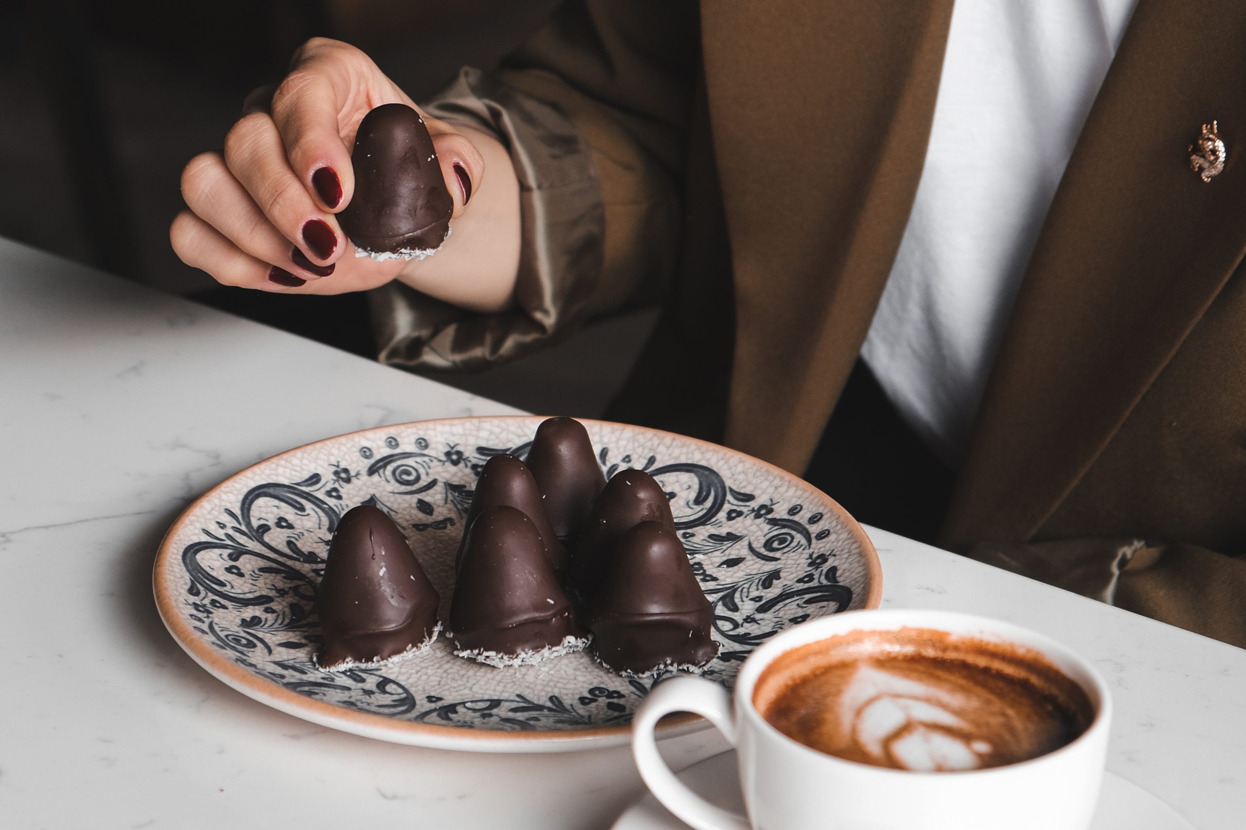 woman enjoying coffee chocolate candies cafe 1