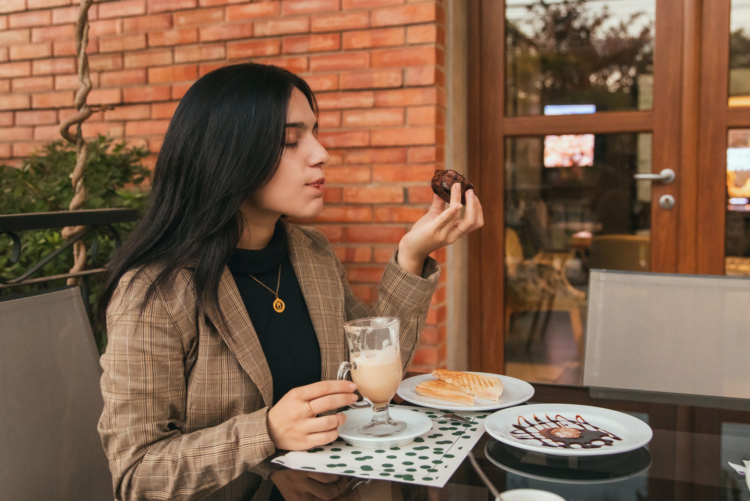 young beautiful girl enjoying a chocolate cupcake